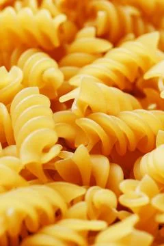 Background texture and pattern of boiled egg noodles in a spiral or pasta spa Stock Photos