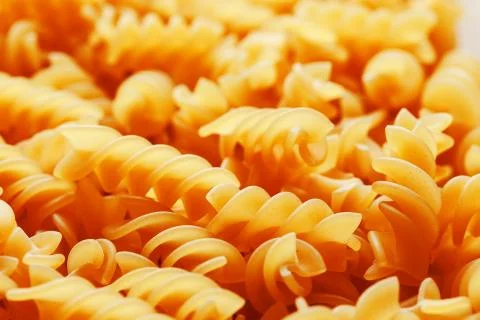 Background texture and pattern of boiled egg noodles in a spiral or pasta spa Stock Photos