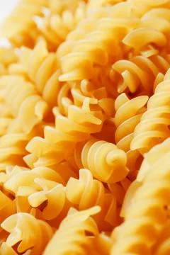 Background texture and pattern of boiled egg noodles in a spiral or pasta spa Stock Photos