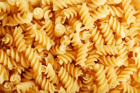 Background texture and pattern of boiled egg noodles in a spiral or pasta s.. Stock Photos
