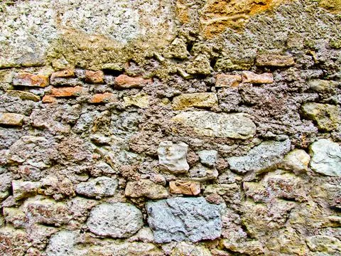 Background texture of an antique stone wall close-up Stock Photos