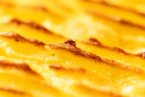 Background with the texture of baked, browned mashed potatoes close-up. Selected Stock Photos