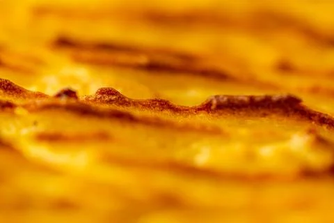 Background with the texture of baked, browned mashed potatoes close-up. Selected Stock Photos