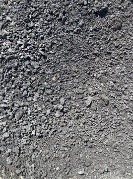 Background texture: black asphalt granulate road surface. Dark gray floor Stock Photos