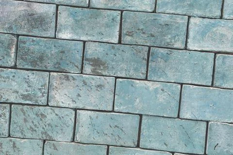 Background texture of a brick wall made of light green blocks, diagonal framing Foto stock