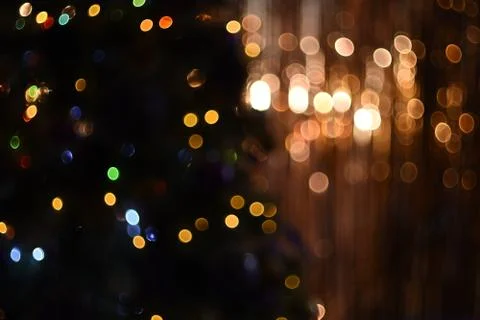 Background texture with bright multicolored glowing lights bokeh on gold and Stock Photos