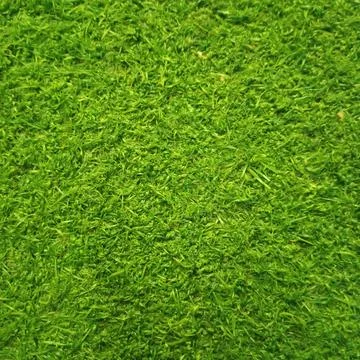 Background texture of bright vibrant artificial green grass turf lawn Foto stock