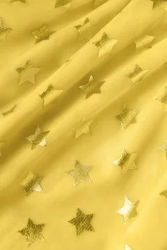 Background, texture of bright yellow mesh fabric with stars. Concept trendy c Foto stock