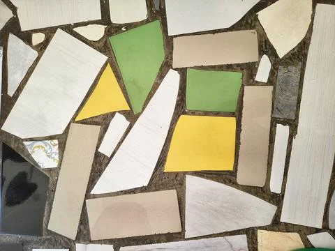 Background texture of broken ceramic tiles mosaic set in cement Stock Photos