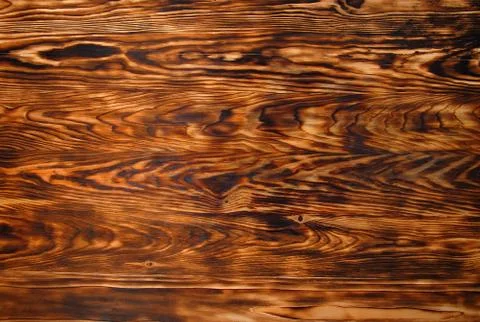 Background texture from burned brown pine wood Stock Photos