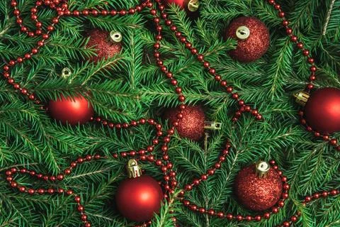 Background texture of Christmas tree branches with red baubles and beads Stock Photos