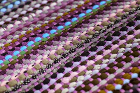 Background, texture of colored handmade carpet. Stock Photos
