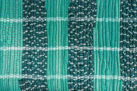 Background, texture of colored handmade carpet. Stock Photos