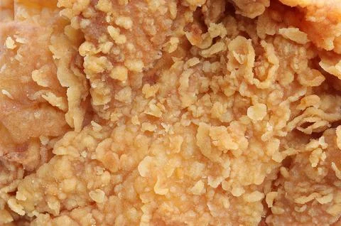 Background, texture of crispy fried chicken. yellow gold crust Stock Photos