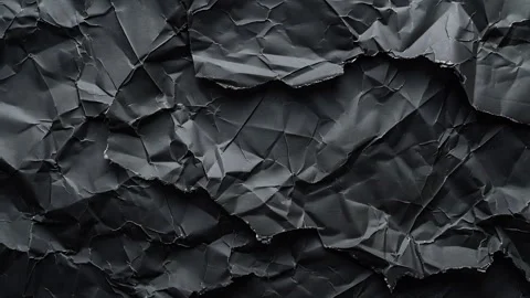 Background of a texture of a crumpled black paper leaf in motion. Blank space Stock Footage 289126017