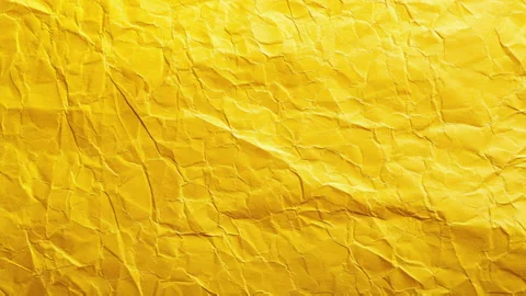 Background of a texture of a crumpled yellow paper leaf in motion. Blank space Stock Footage 280001757
