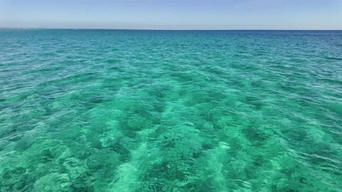 Background texture of crystal-clear, rippling aquamarine waters at Rosebud Stock Footage 306631352