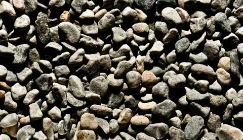 Background texture of dark smooth pebbles Stock Photos