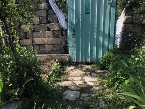 Background texture door wickets to enter the garden patch fence of mesh, behi Stock Photos