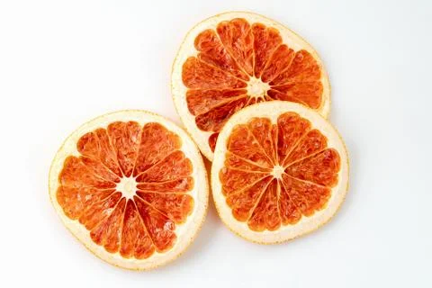 Background texture with dried grapefruit citrus slices on a white background Stock Photos