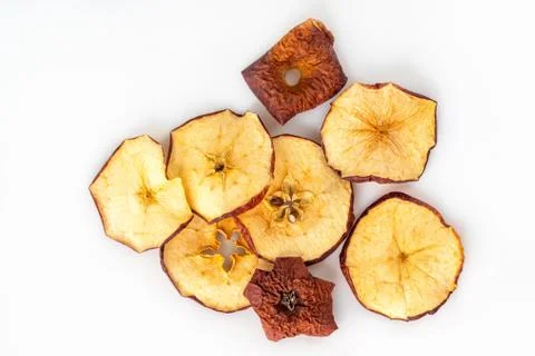 Background texture with dried slices of red apples on a white background Stock Photos