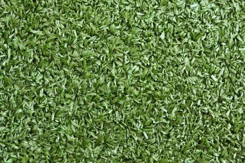 Background texture with fake grass in a public children playgrou Stock Photos