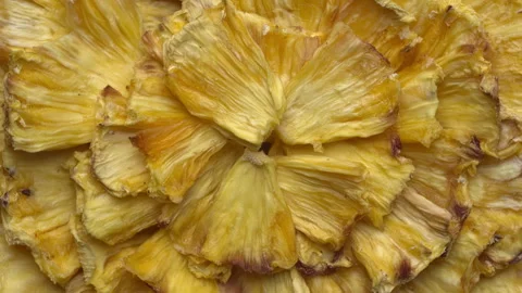 Background texture formed from home-dried pineapple slices. Table spin. Stock Footage 308076076