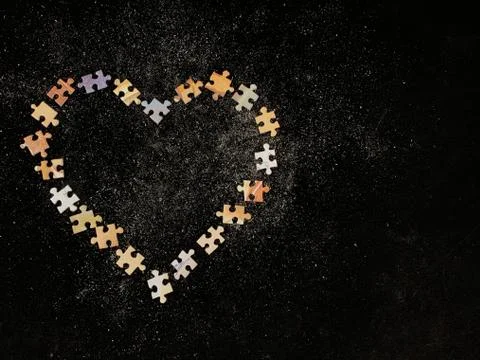 Background texture: heart shape on puzzle paper background.  Stock Photos