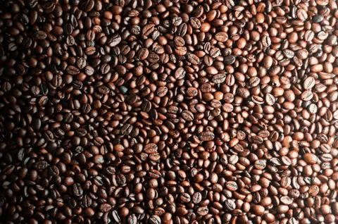 Background texture of a huge number of fragrant and fresh brown roasted coffe Stock Photos