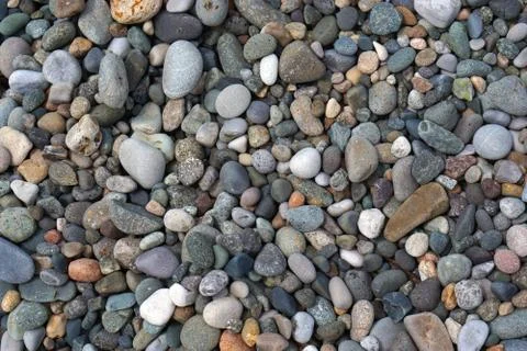 Background, texture of the large and small sea stones lying on the beach Фото
