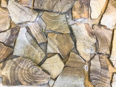 The background, the texture of large fragments of large carved brown sharp st Stock Photos