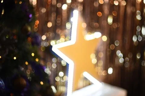 Background texture large glowing star and fir tree on the background of golden Stock Photos