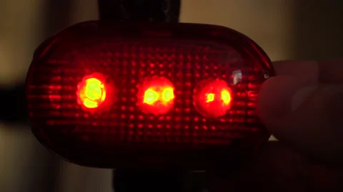 Background texture LED red lantern for bike hand presses button switching mode Stock Footage 149325772