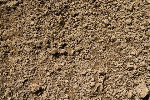 Background texture from the loose surface of the sand and earth soil. top vie Stock Photos