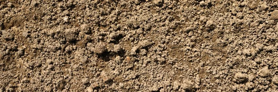 Background texture from the loose surface of the sand and earth soil. top vie Stock Photos
