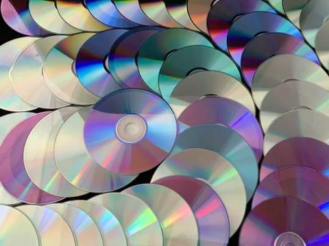 Background texture: a lot of computer disks. Music CDs on a black background, Stock Photos