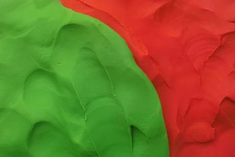A background texture made out of green and red play clay. Close up. Stock Photos