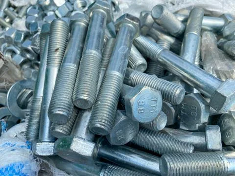 Background, texture of many metal small iron bolts and stainless steel fasten Stock Photos