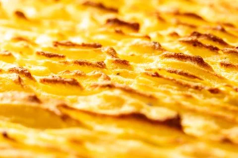 A background with the texture of mashed potatoes baked until golden brown in the Stock Photos