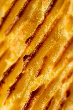 A background with the texture of mashed potatoes baked until golden brown in the Stock Photos