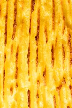 A background with the texture of mashed potatoes baked until golden brown in the Stock Photos