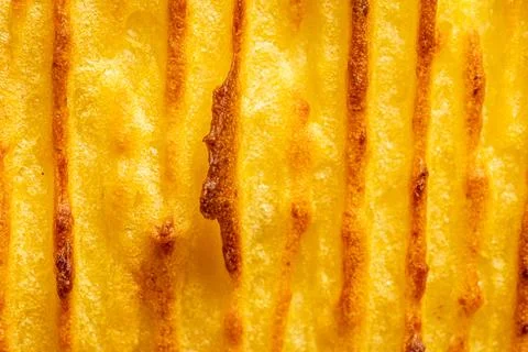 A background with the texture of mashed potatoes baked until golden brown in the Stock Photos