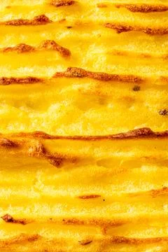 A background with the texture of mashed potatoes baked until golden brown in the Foto stock