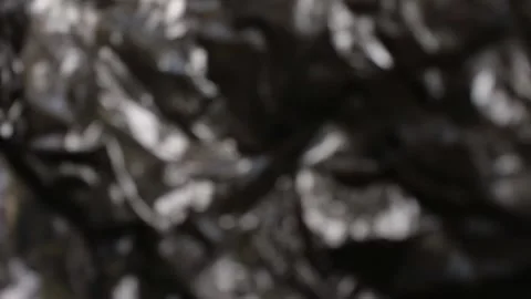 The background texture is matted and blurred from black plastic 스톡 동영상 286992002