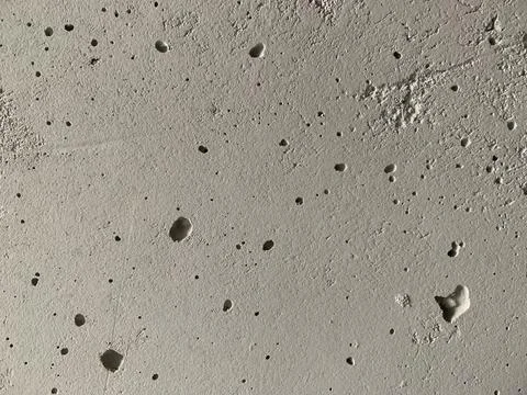 Background texture: old concrete wall. Wall with small holes and gray crack.. Stock Photos