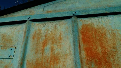Background texture of an old rusty garage made of sheets of metal in bright Stock Footage 125804019