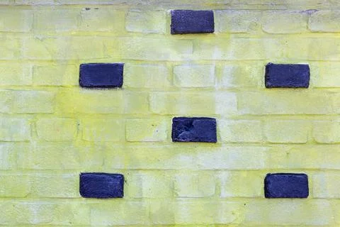 Background texture of a old yellow brick wall. Stock Photos