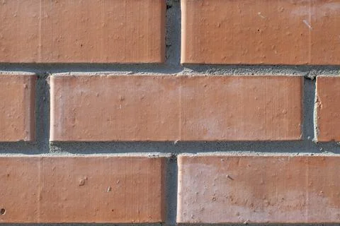 Background, texture, pattern of smooth, geometrically adjusted neat red brick Stock Photos