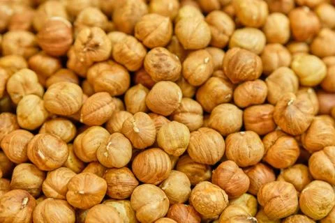 Background texture of peeled hazelnuts. Top view. Stock Photos