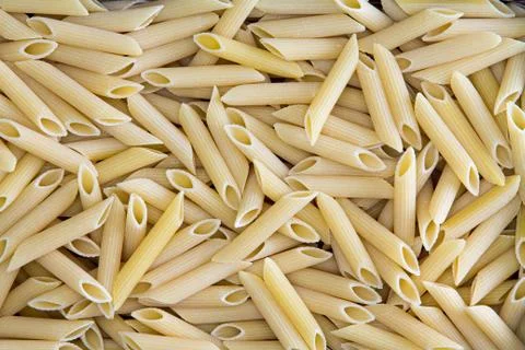 Background texture of penne, rigate or ziti pasta Stock Photos